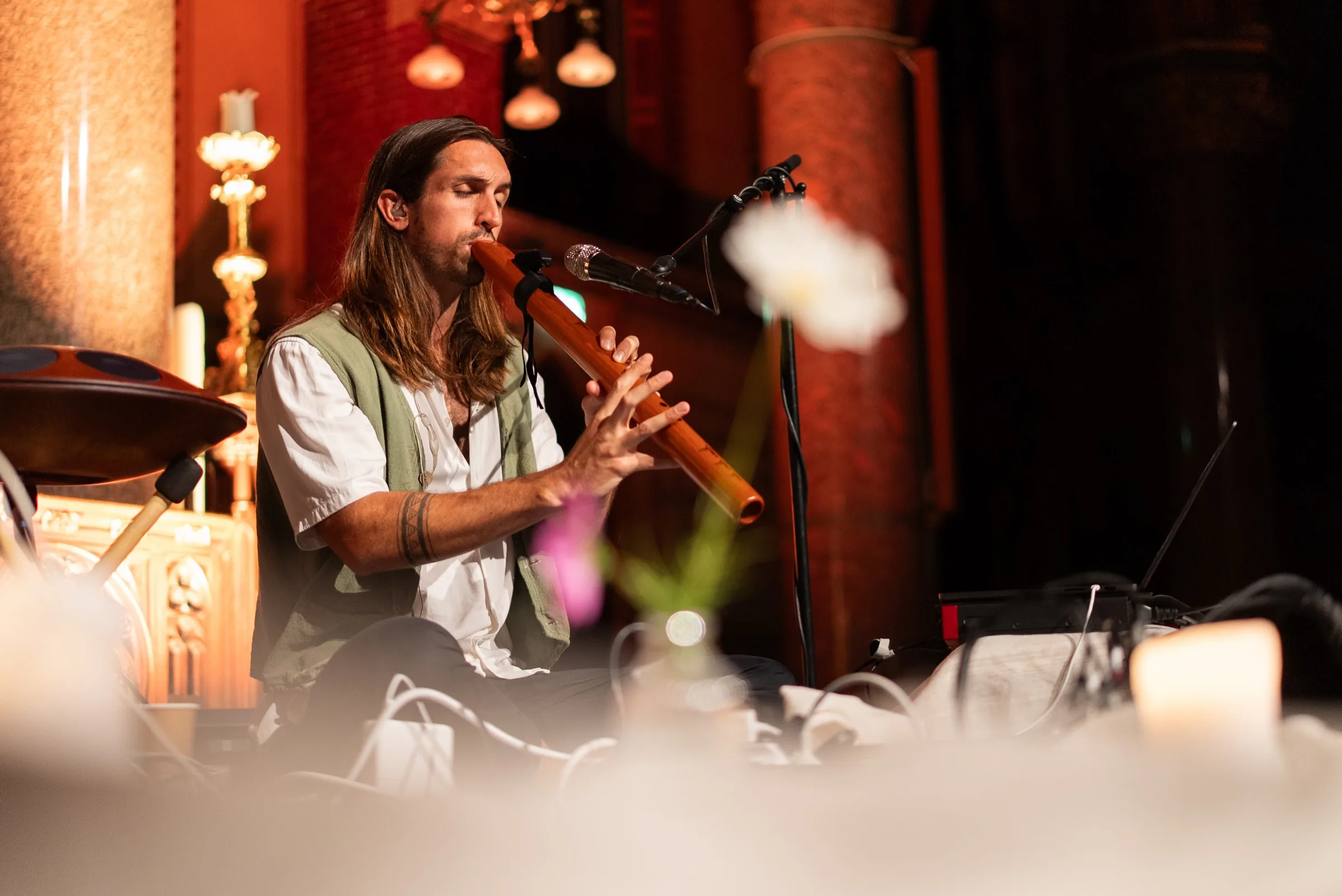 Sandy playing a wooden flute during the breathwork concert