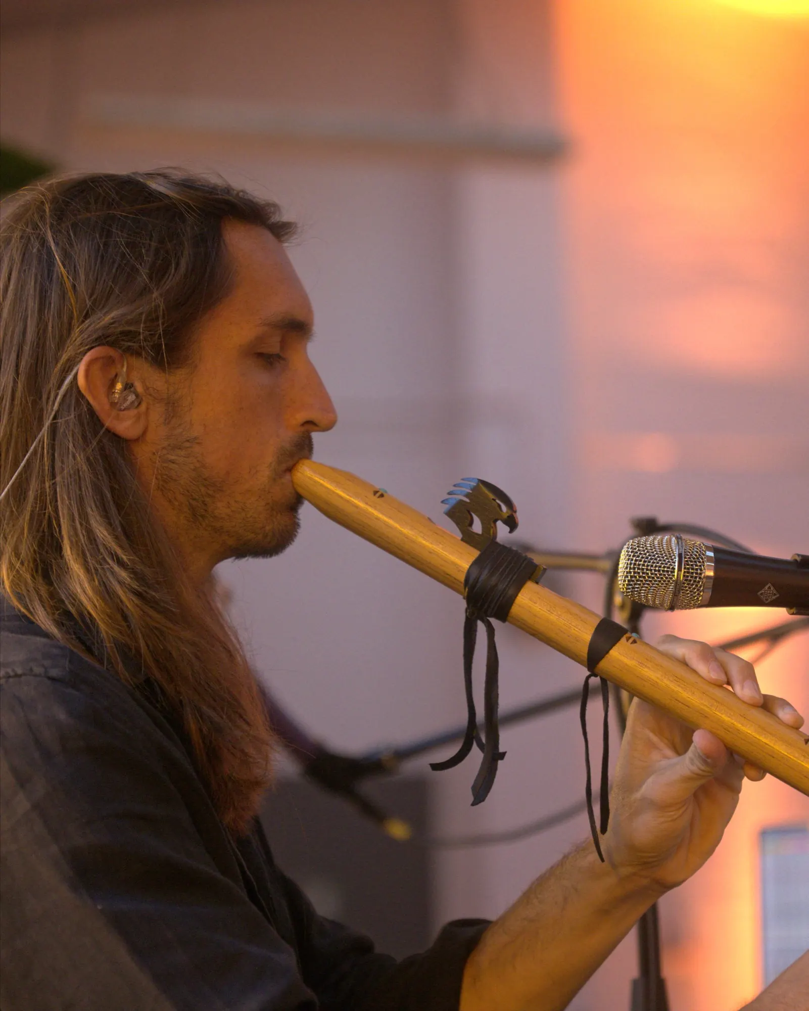 Sandy playing a wooden flute in Munich